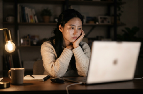 밤에 스탠드를 켜고 노트북을 보며 고민하는 여성의 구글 SEO 걱정